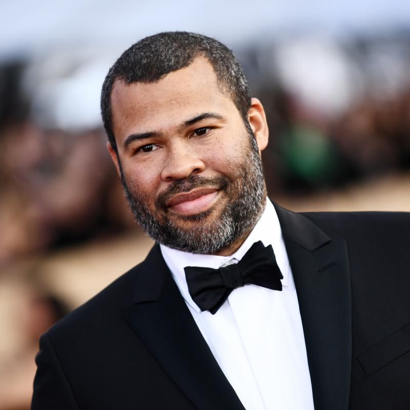 Actor and Director Jordan Peele at an award show in a black tuxedo