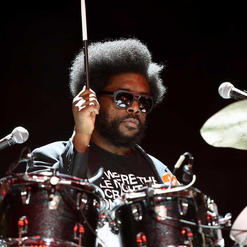 Roots drummer Questlove (Ahmir Thompson) playing drums in sunglasses