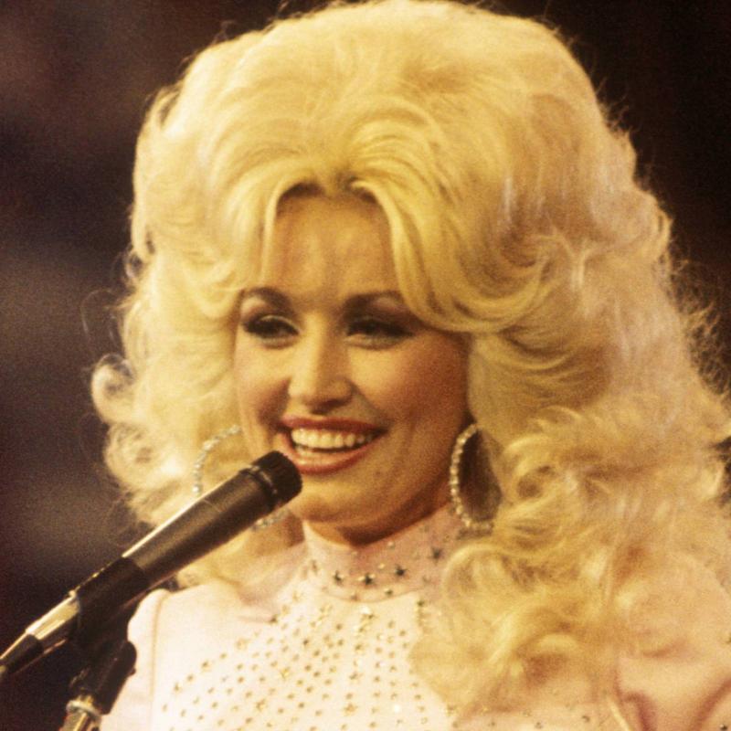 Dolly Parton sings in this image from 1976