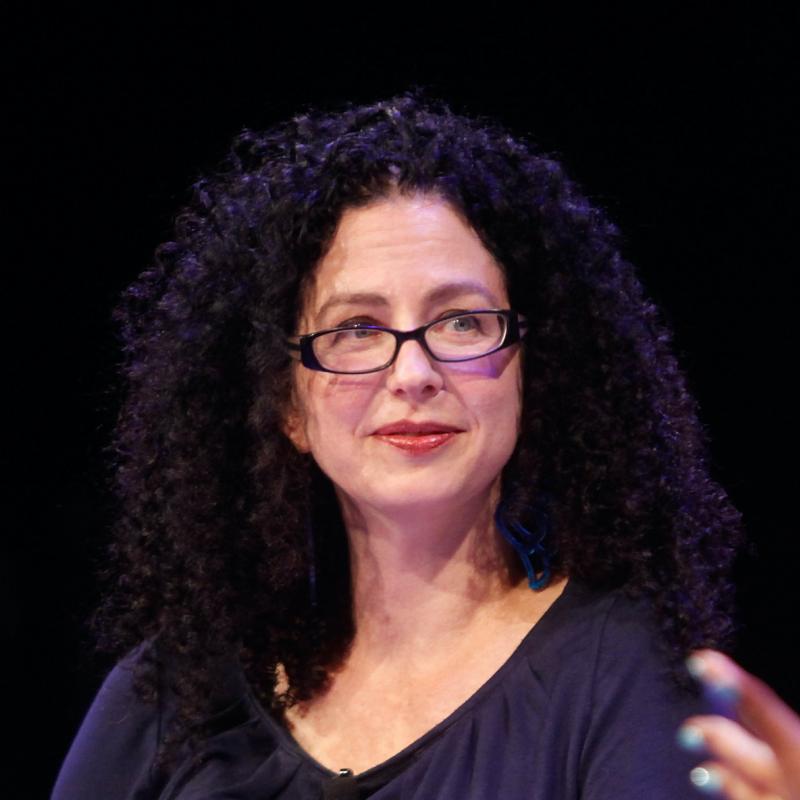 TV critic Emily Nussbaum smiles against a black backdrop