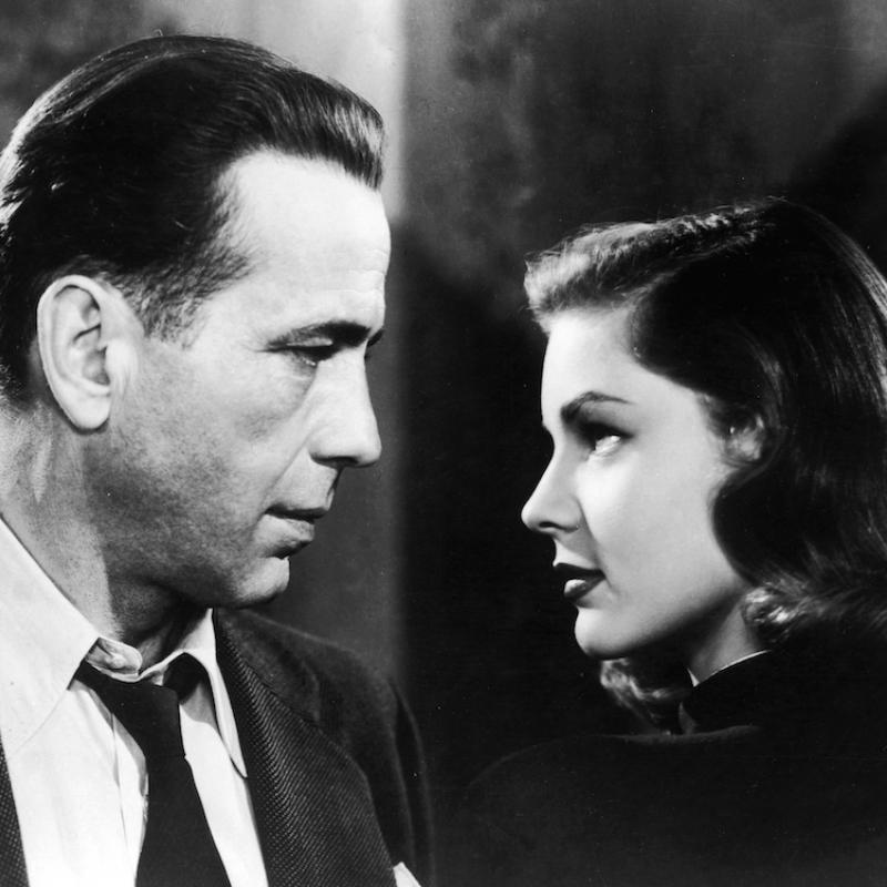 Actress Lauren Bacall and actor Humphrey Bogart look into each other's eyes on the set of the movie 'The Big Sleep'