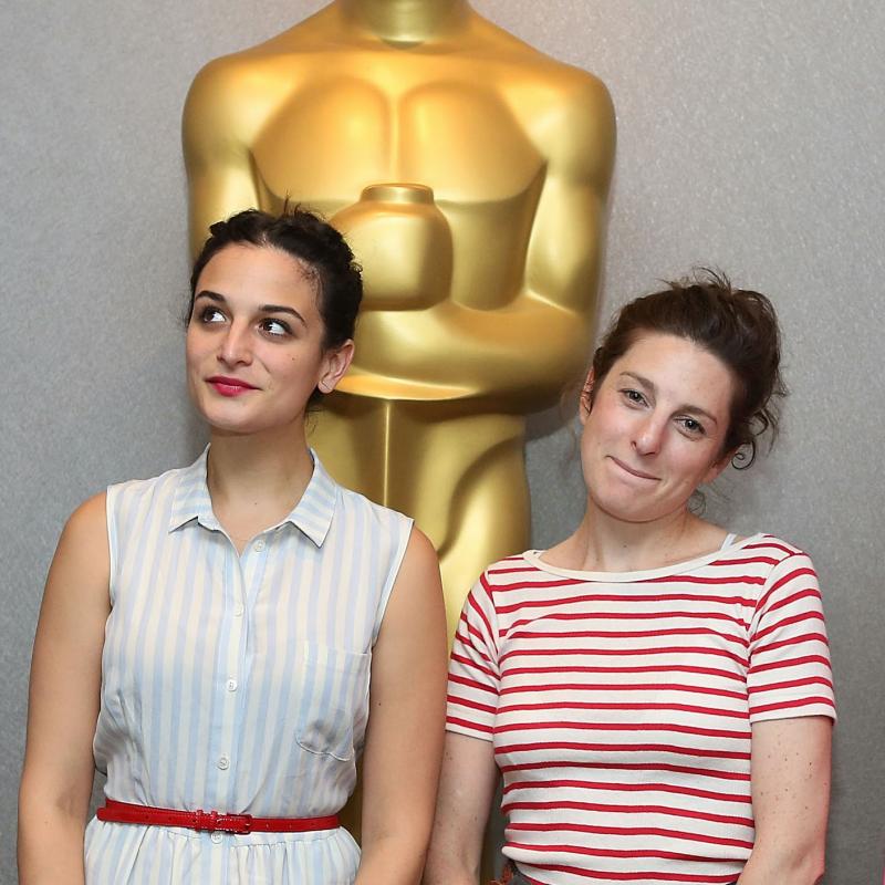 Actress Jenny Slate and director Gillian Robespierre stand in front of an oversized Oscar statue