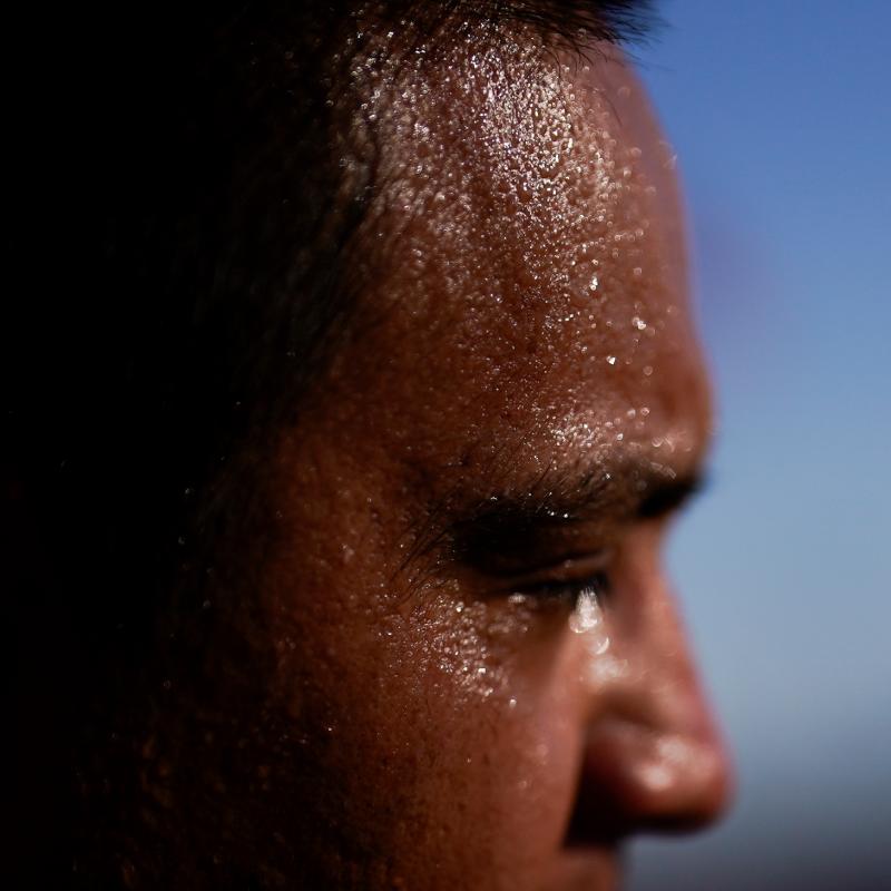 A close up of sweat covering the face of a person on a hot day